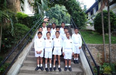 Group of 12 Junior School students from the Oriental Music Society standing on steps