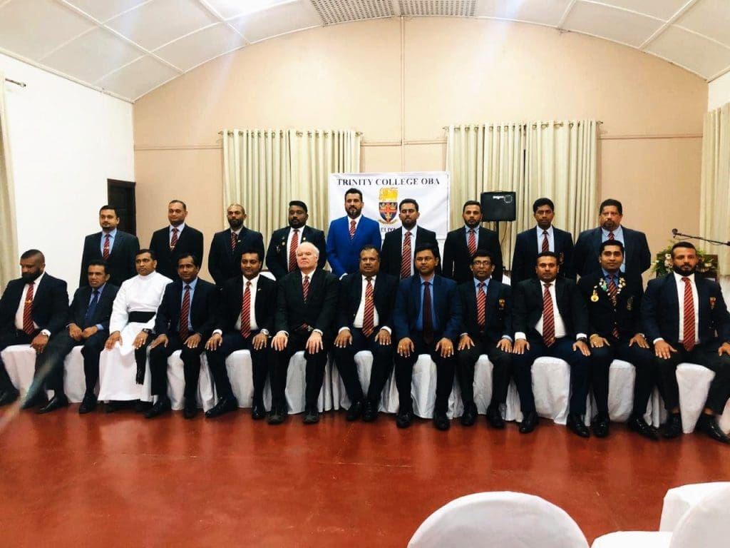 Committee members sitting and standing for a group photograph