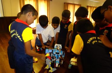 Young students around a lego robot